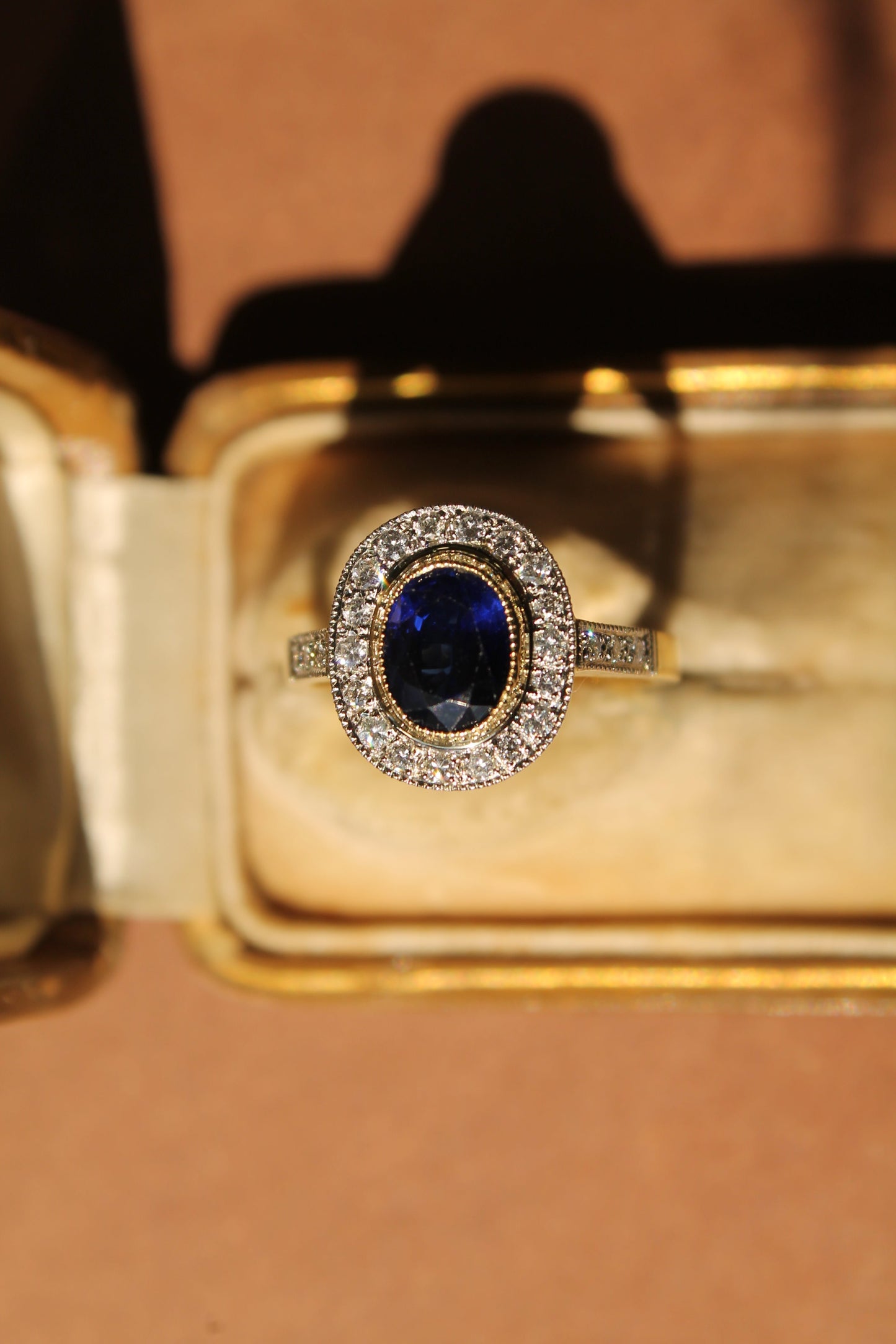 Anillo halo oval a pedido, platino, oro amarillo, zafiro y brillantes.