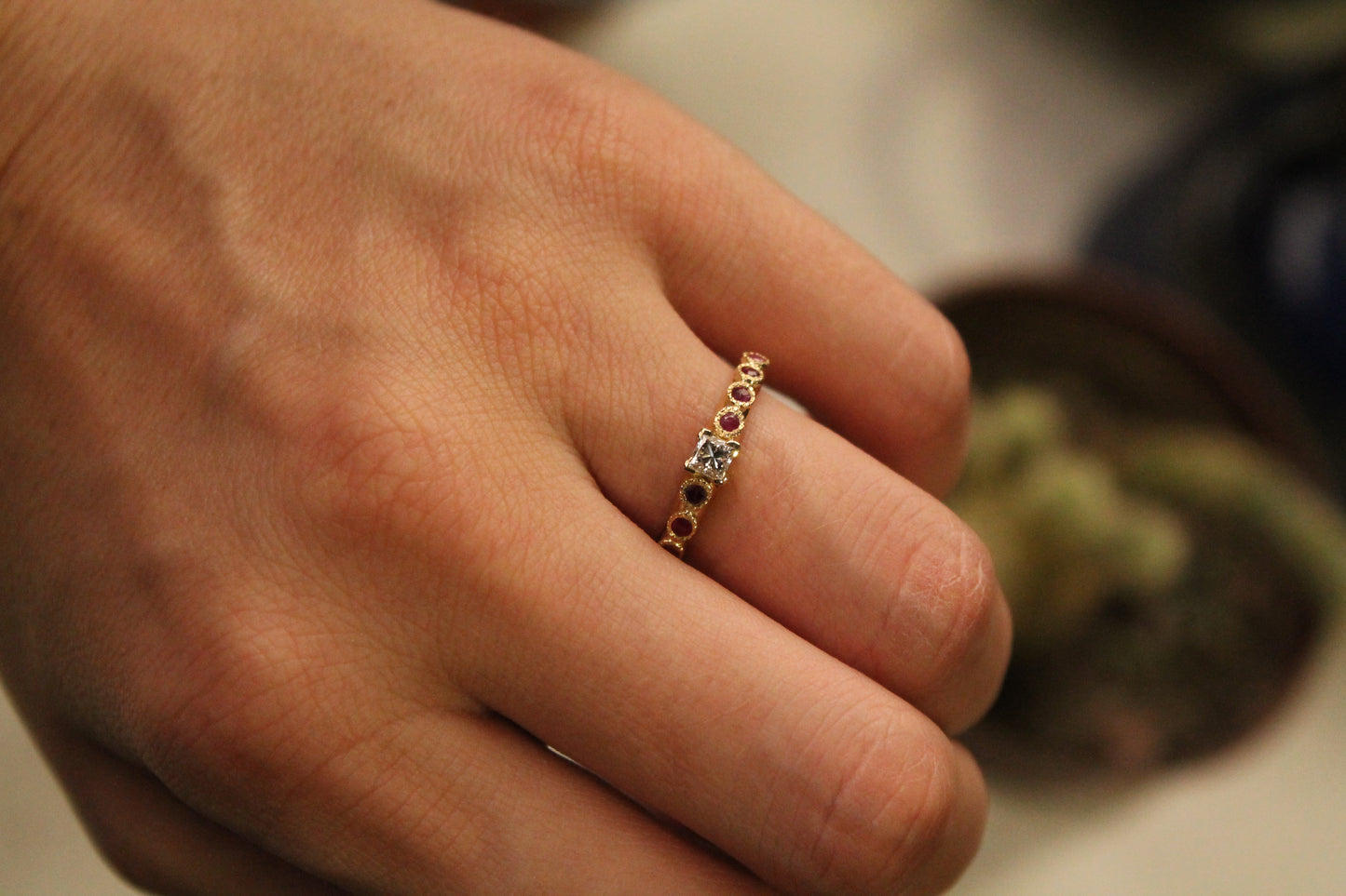 Anillo solitario europeo, oro amarillo, rubíes y diamante princesa.