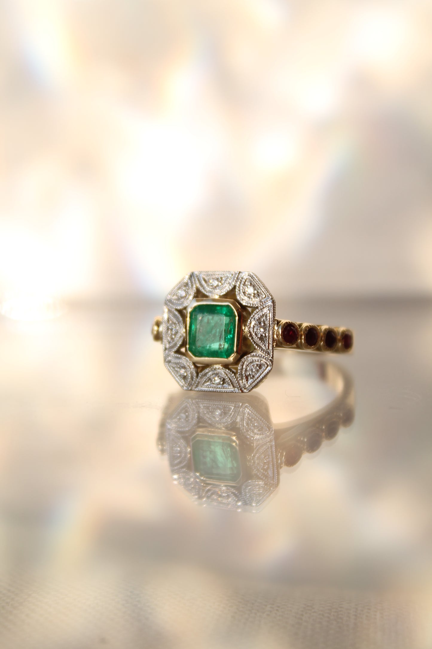 Anillo a pedido, hecho a mano, de metal platino, oro amarillo, Esmeralda, brillantes y rubíes.